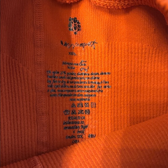 Free People Movement Happiness Runs ribbed leggings in a bright orange color. - Picture 2 of 3